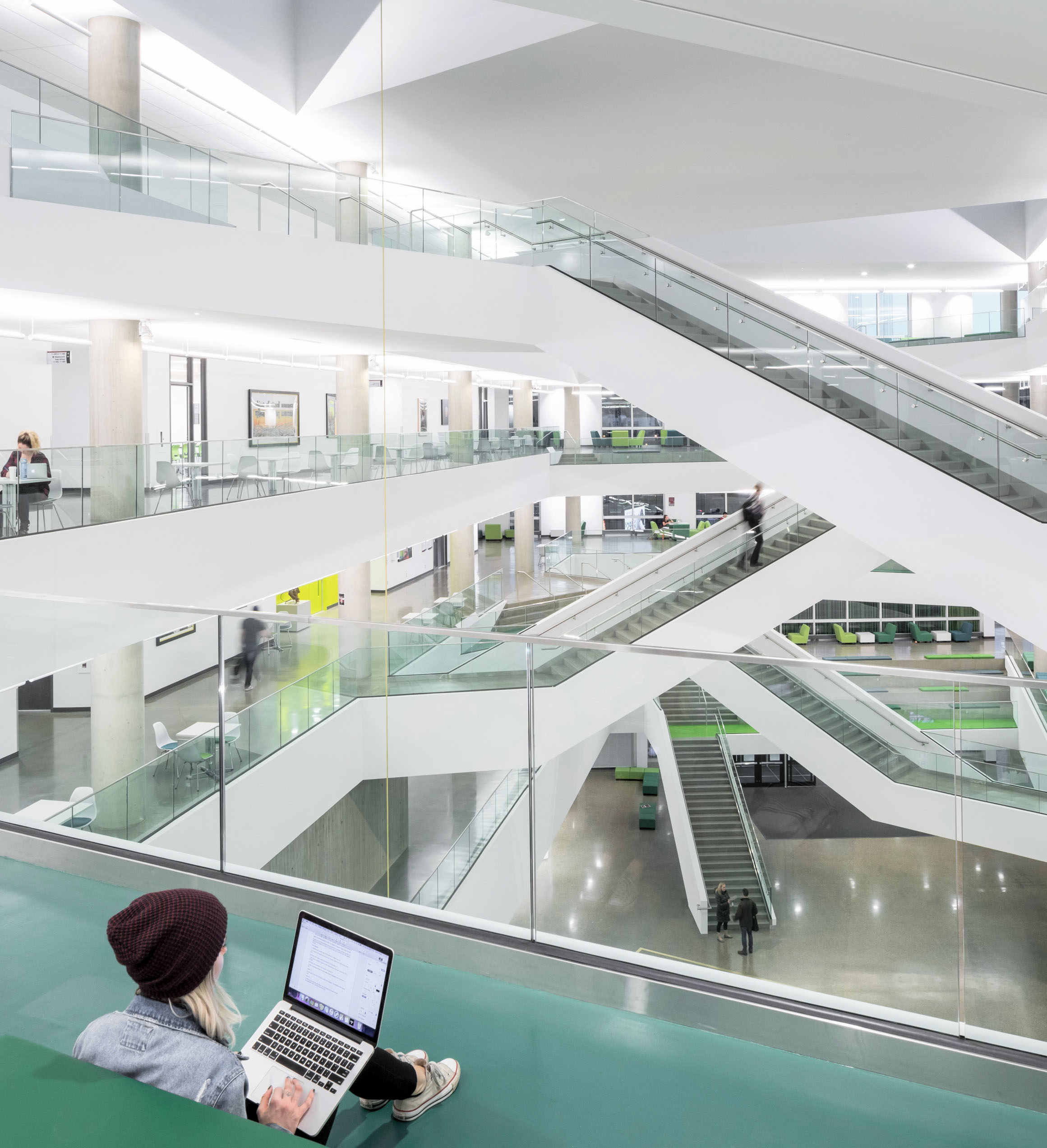 Students working in the atrium at MacEwan University