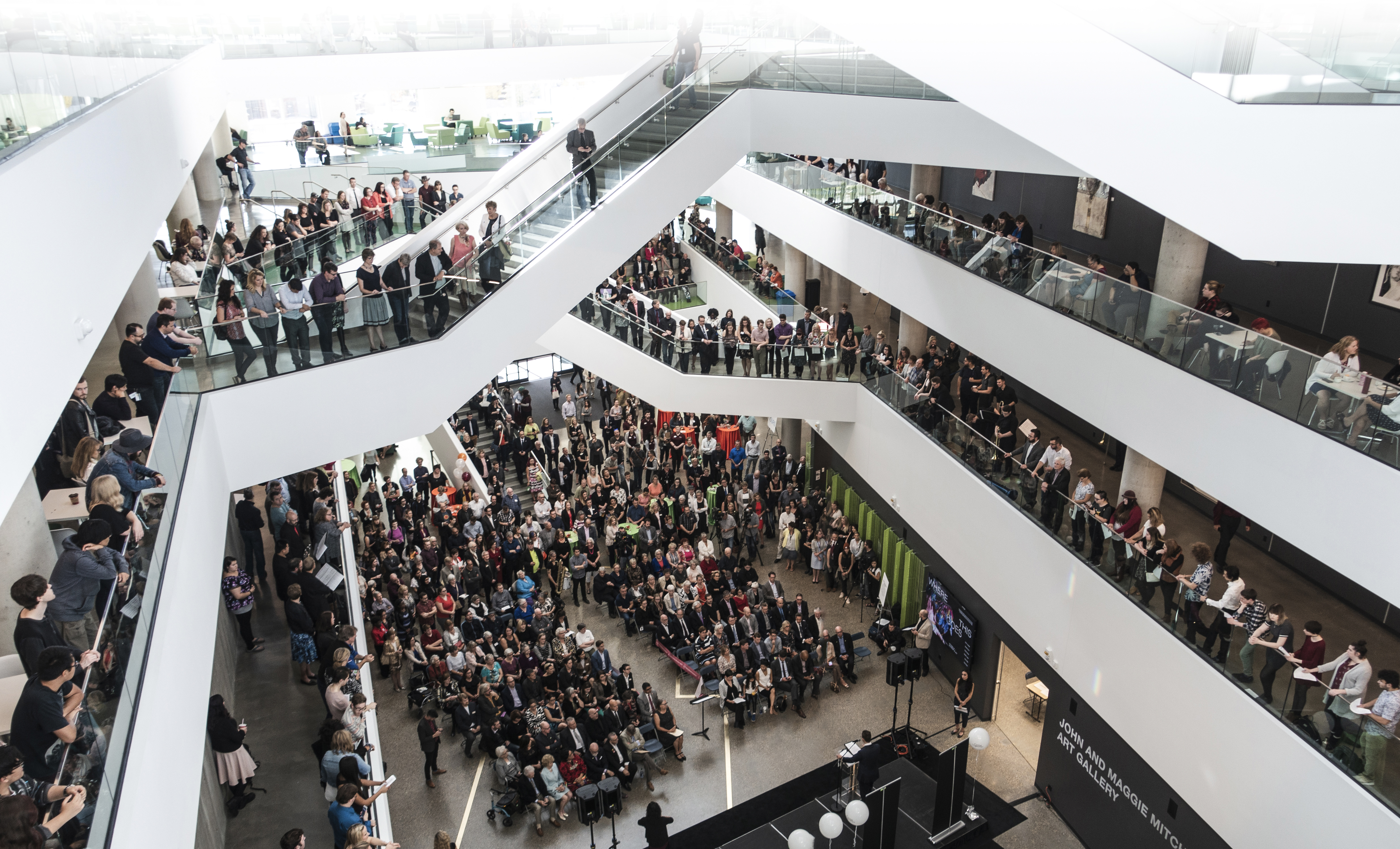 Large gathering in the atrium at MacEwan University's Allard Hall