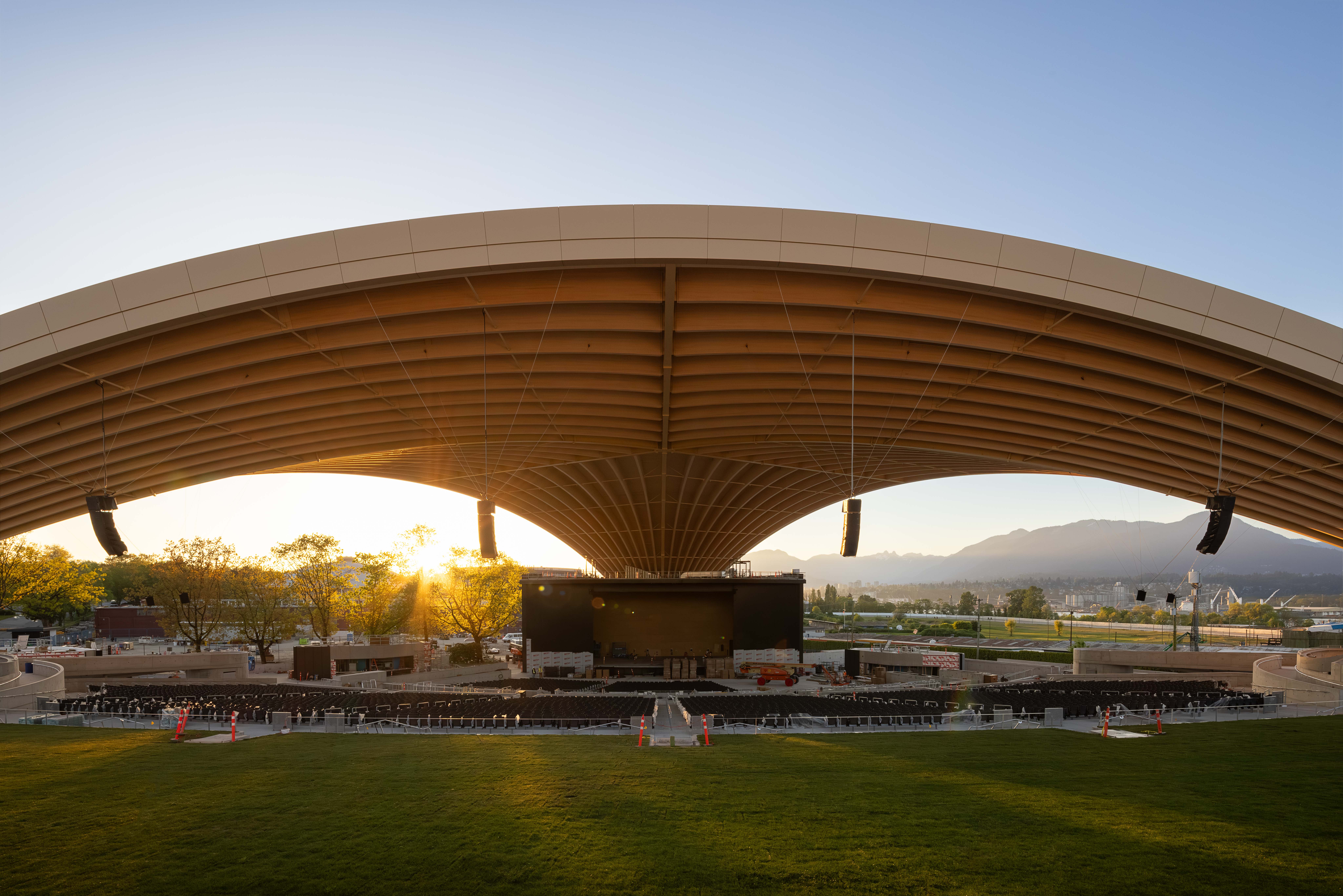 PNE Amphitheatre by Revery Architecture, Vancouver, BC - ground sunset view of long-span mass timber roof