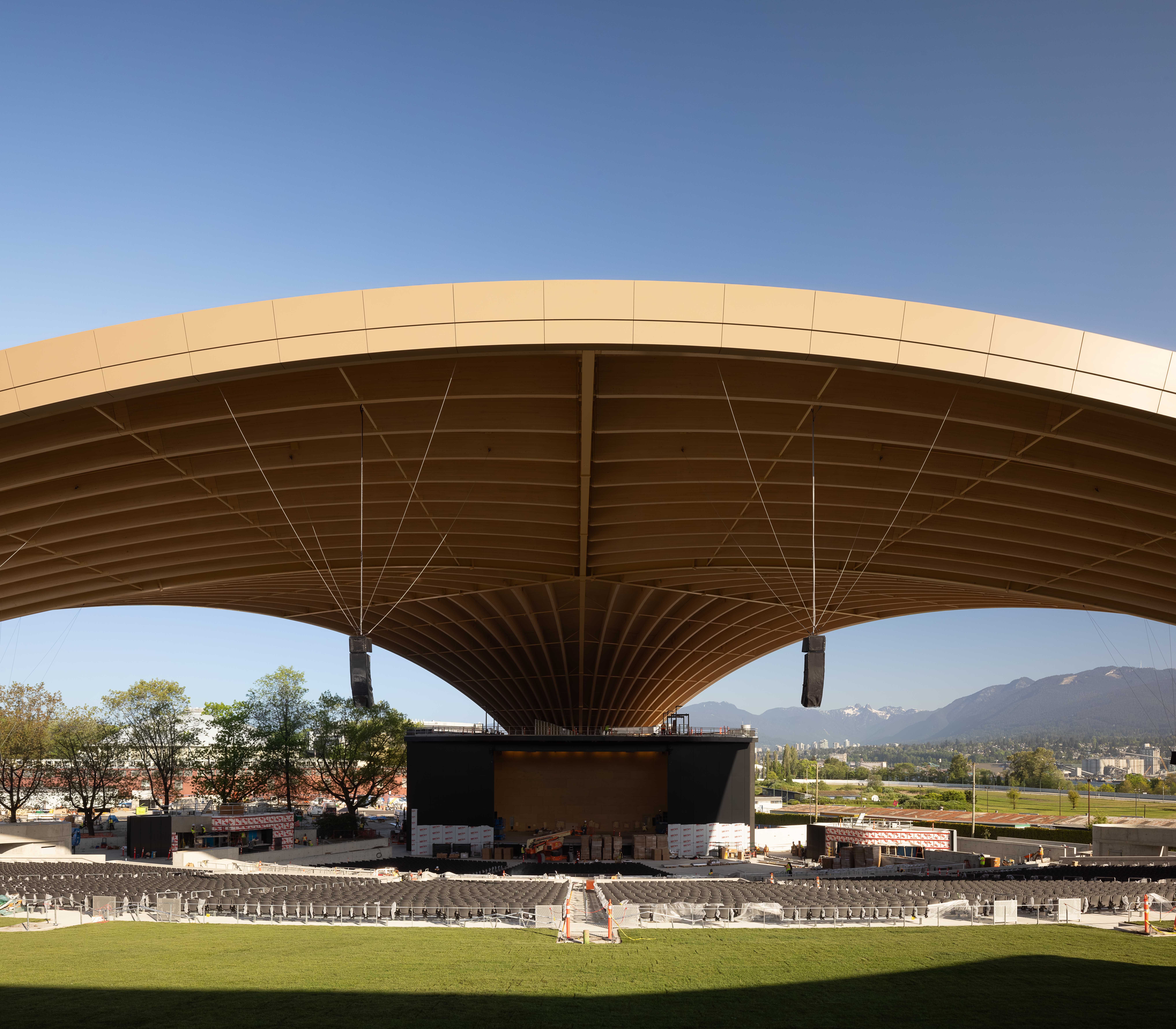 PNE Amphitheatre by Revery Architecture, Vancouver, BC - ground sunset view of long-span mass timber roof