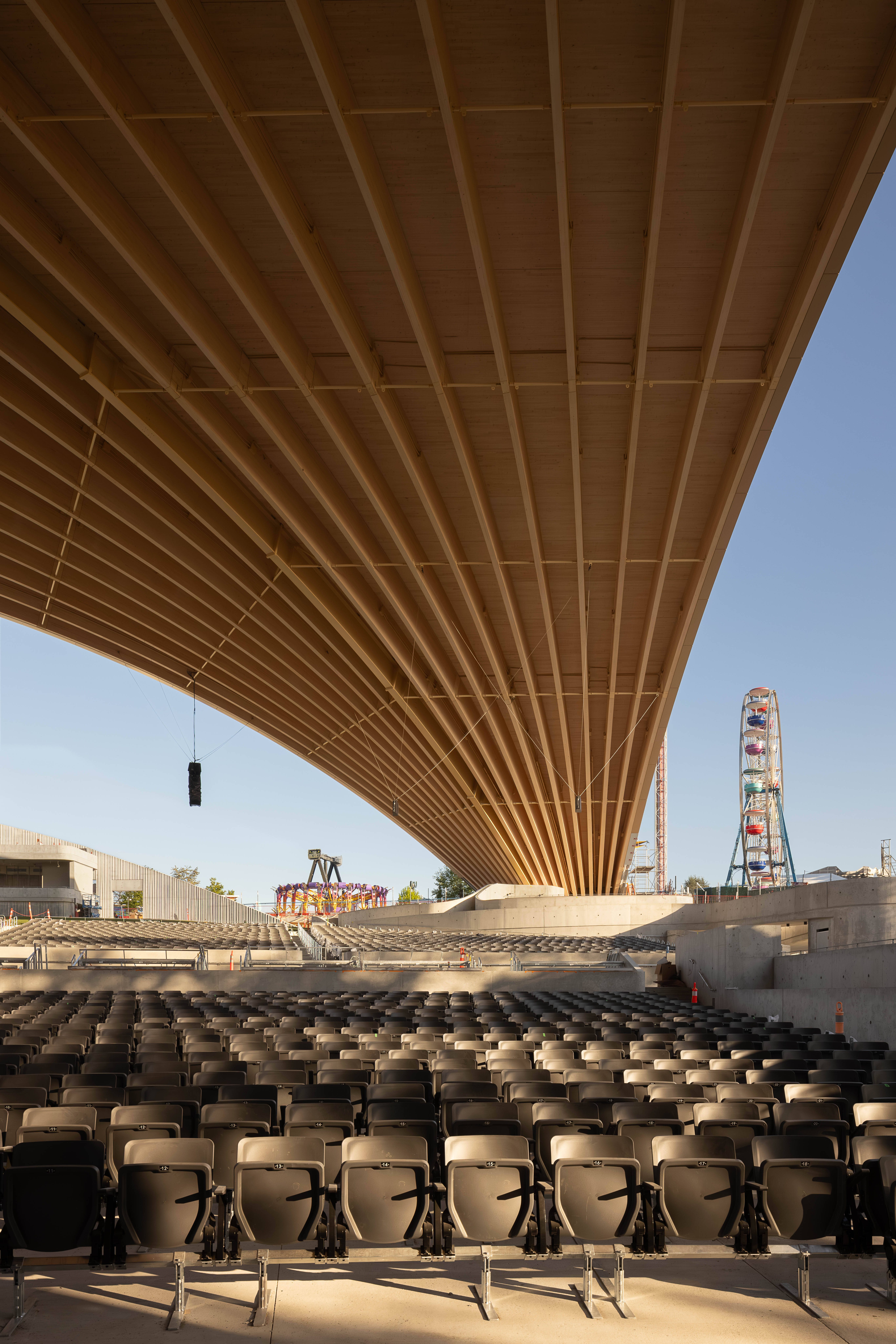 PNE Amphitheatre by Revery Architecture, Vancouver, BC - interior open air view of long-span mass timber roof